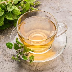 cup-of-tea-drink-with-fresh-leaves-of-peppermint-melissa-gray-background-healing-herbal-drink.jpg