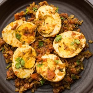 Masala Egg Tawa Fry or ande ki sabzi, served in a plate. selective focus