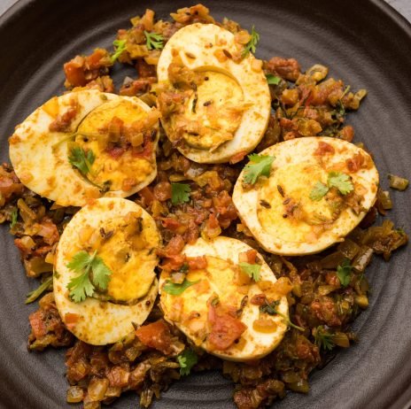 Masala Egg Tawa Fry or ande ki sabzi, served in a plate. selective focus